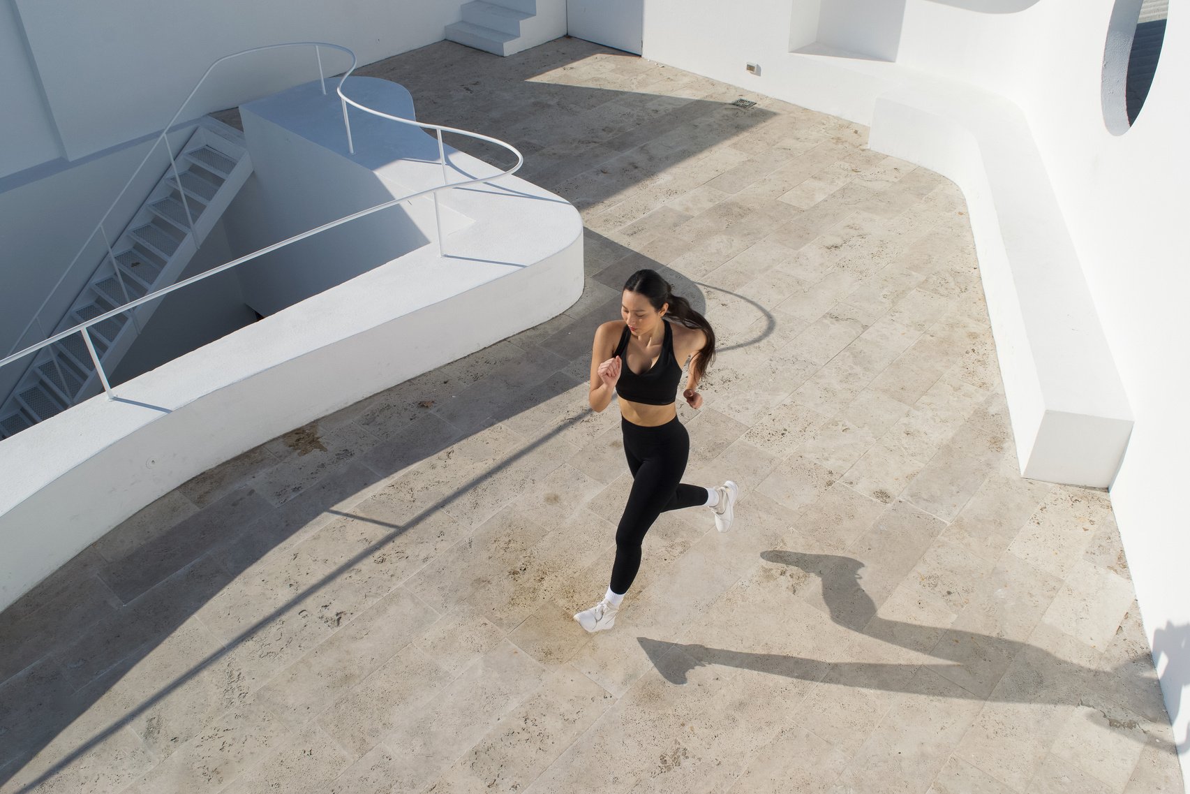 Woman in Black Activewear Running Outdoors